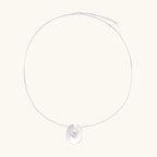 Sterling silver disc necklace with textured finish and centered freshwater pearl on delicate chain